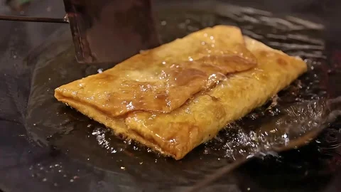 Frying egg martabak while behind the egg martabak Stock Footage 270347181