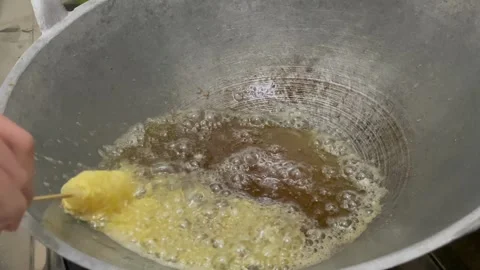 Frying egg noodle roll In hot oil Stock Footage 324750437