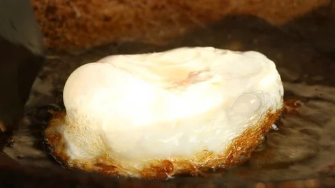 Frying egg in pan close up Stock Footage 98625863