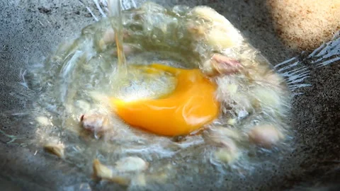 Frying egg  in pan, in door  Chiangmai  Thailand Stock Footage 138507826