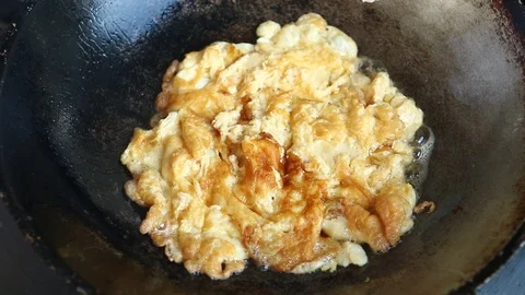 Frying egg in pan Stock Footage 97174314