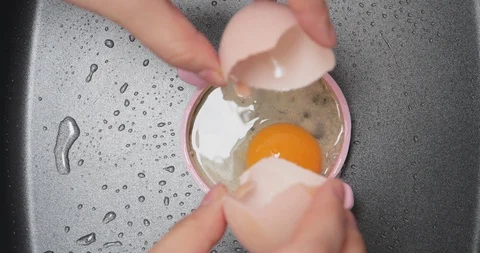 Frying egg on a pan with a ring Stock Footage