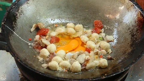 Frying egg with pork and meat ball in pan, outdoor Chiangmai Thailand Stock Footage 118354471