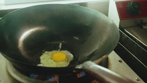 Frying Egg in Wok Pan on Gas Stove for Pad Thai Noodles Stock Footage 321859704