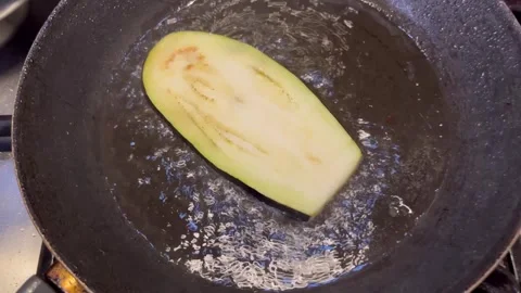 Frying Eggplant Slices in a Pan Stock Footage 345321019
