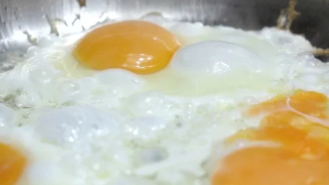 Frying eggs 4K Stock Footage 107019502