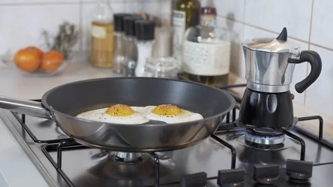 Frying eggs and making coffee Stock Footage 127102638
