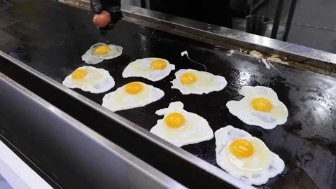 Frying Eggs on a Hot Griddle Stock Footage 331956472