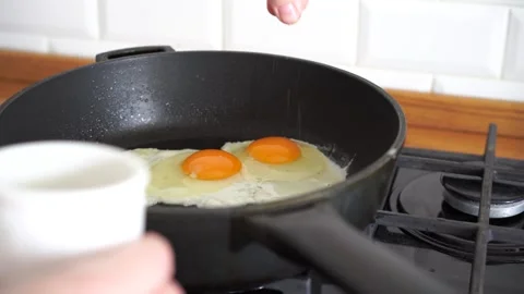 Frying eggs on hot pan at home kitchen. Stock Footage 244515842