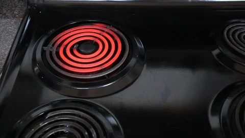 Frying eggs in a pan on a black stove Stock Footage 89695716