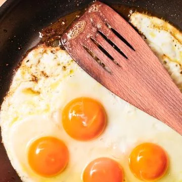 Frying eggs Stock Photos