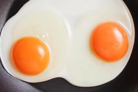 Frying eggs Stock Photos