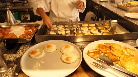 Frying eggs in round metal molds in the kitchen of a hotel restaurant 3 Stock-Footage 294322277