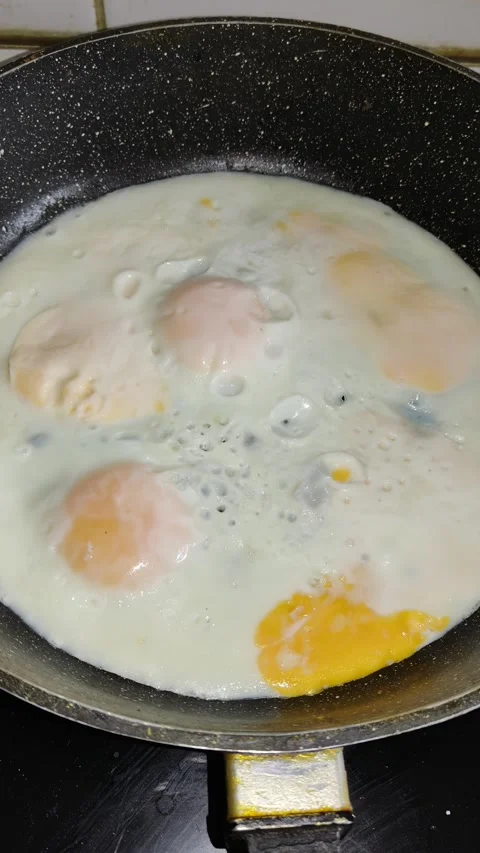 Frying Eggs in a Skillet Stock Footage 346524128