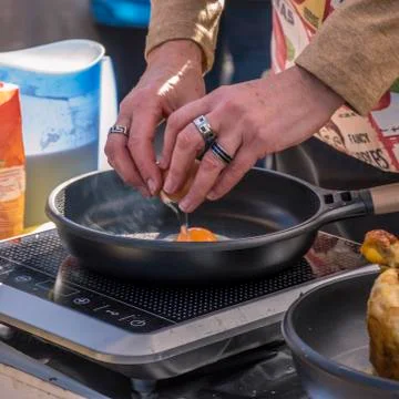 Frying eggs in a street store in old Madrid Stock Photos