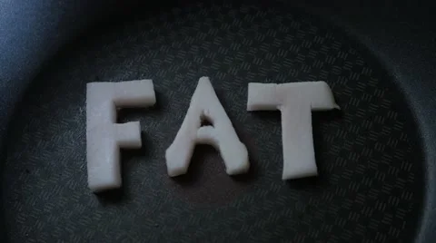 Frying "FAT" as Word in a frying pan 스톡 동영상 68940974