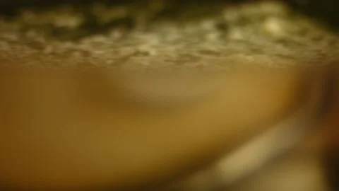 Frying finely grated garlic and chopped rosemary leaves in a black frying pan Stock Footage 151334977