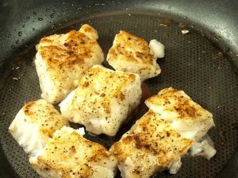 Frying fish, frying pan Stock Photos