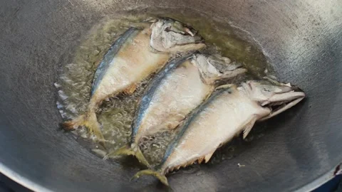 Frying fish in a pan Stock Footage 164189747