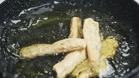 Frying fish roll on a pan slowmotion Stock Footage 247826830
