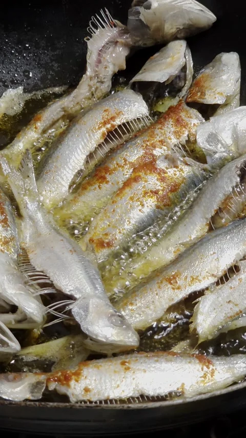Frying Fish In Spicy Oil in Pan Stock Footage 335095337