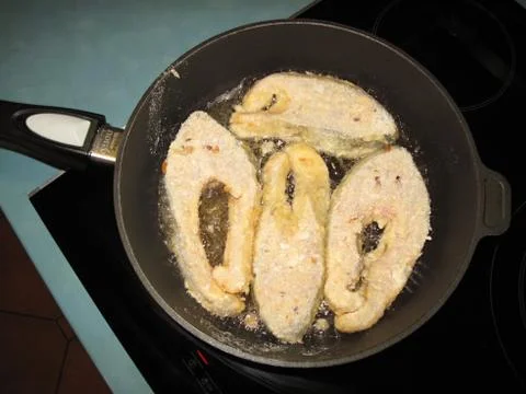 Frying fish steaks in the pan  Stock Photos