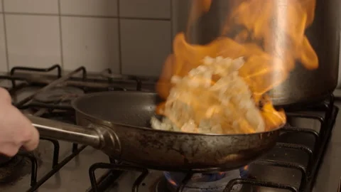 Frying food in pan over fire Video stock 238641155