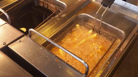 Frying food in a restaurant kitchen during lunch rush Stock Footage 340122559