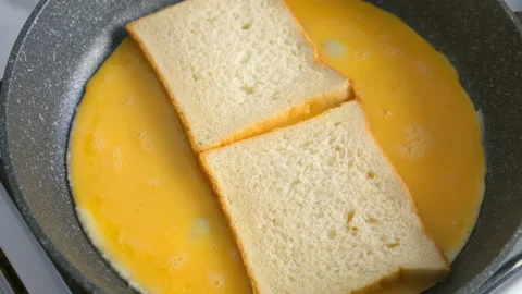 Frying fresh bread for sandwich with egg on skillet cooking at home. Video stock 318214822