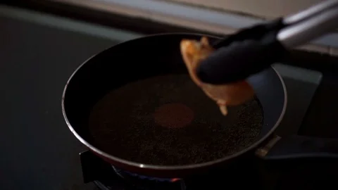 Frying fresh chicken meat in hot oil pan Stock Footage 109419246