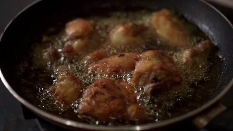 Frying fresh chicken meat in hot oil pan Stock Footage 109420172