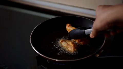 Frying fresh chicken meat mix with turmeric in  hot oil using pan Stock Footage 109420988