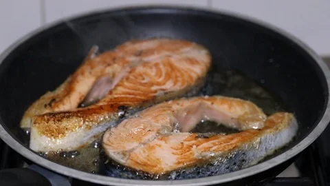 Frying fresh salmon in frying pan Stock Footage 105867544