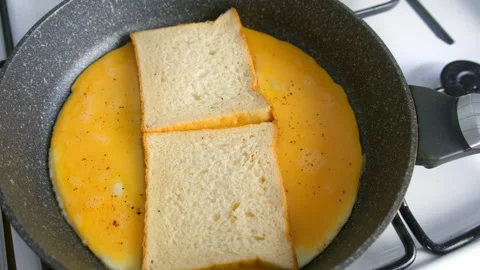 Frying fresh white bread for sandwich with egg on skillet cooking at home. Video stock 318214961