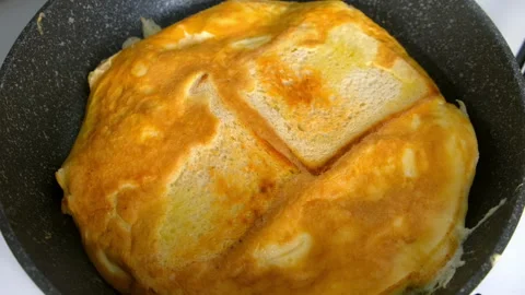 Frying fresh white bread for sandwich with egg on skillet cooking at home. Stock Footage 318215349