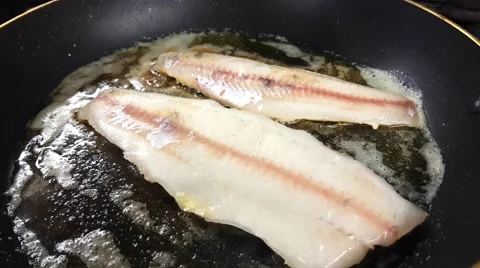 Frying fresh zander fillets, on a frying pan, inside a restaurant kitchen Stock Footage 63393457