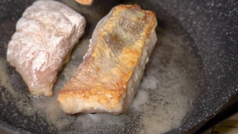 Frying fresh zander fillets, on a frying pan Stock Footage 253279052