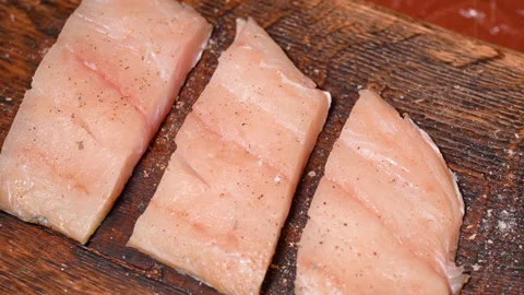 Frying fresh zander fillets, rubbed with spices for further fattening Stock Footage 253277286