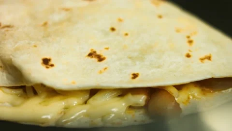 Frying a freshly wraped vegetable quesadilla on a frying pan. Process of making Stock Footage 151295251