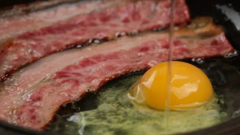 Frying fried eggs with Bacon in hot pan Stock Footage 204852407