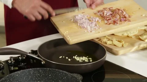 Frying garlic and shallot and bacon on a pan Stock Footage 49781609