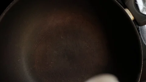 Frying garlic overhead Stock Footage 98360952