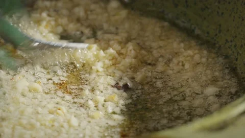 Frying garlic on pan Stock Footage 138127590