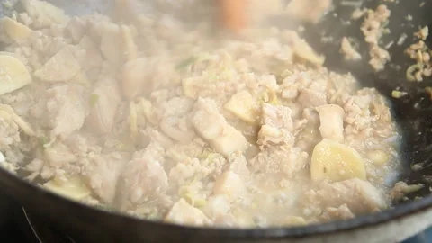 Frying  ginger with chopped pork and chili paste in pan, Chiangmai Thailand Video stock 163332314