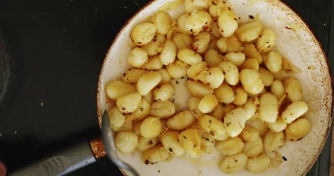 Frying gnocchi Stock Footage 244949406