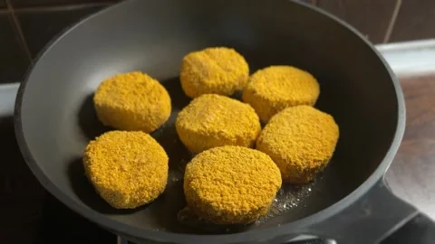 Frying golden breaded cutlets in oil on kitchen pan Stock Footage 310503398