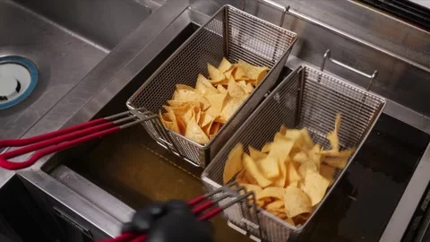 Frying Golden Tortilla Chips in Hot Oil for Nachos Stock Footage 331634677