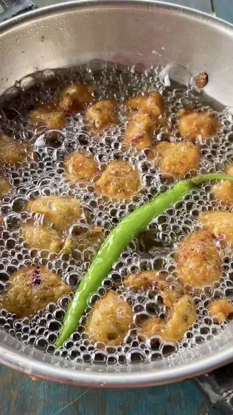 Frying Gram Beans pakora or mong dal pakoda in a frying pan. Stock Footage 286215669