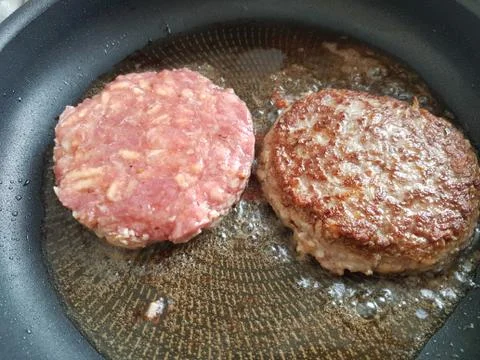 Frying hamburger cutlets Stock Photos