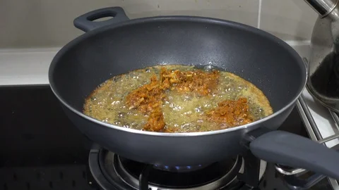 Frying a herbs chicken in a wok Stock Footage 101106978